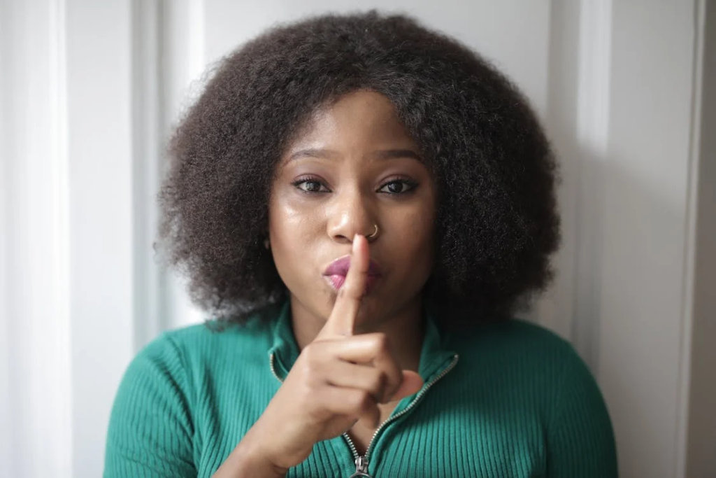 Marketing lesson from DuckDuckGo and Disco: Sometimes attack the competition. Image by Andrea Piacquadio via Pexels. A woman is holding her index fingers to her lips in a shushing motion